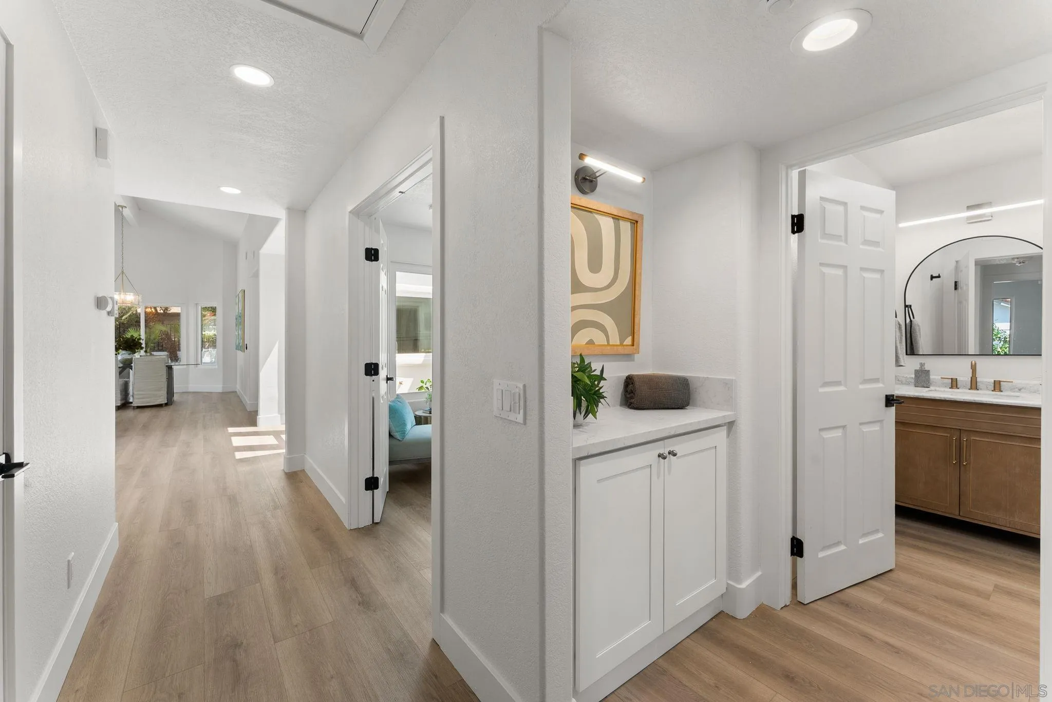 4714 Athos Way Oceanside, CA 92056 - Photo 19 of 34 a view of hallway with kitchen and wooden floor