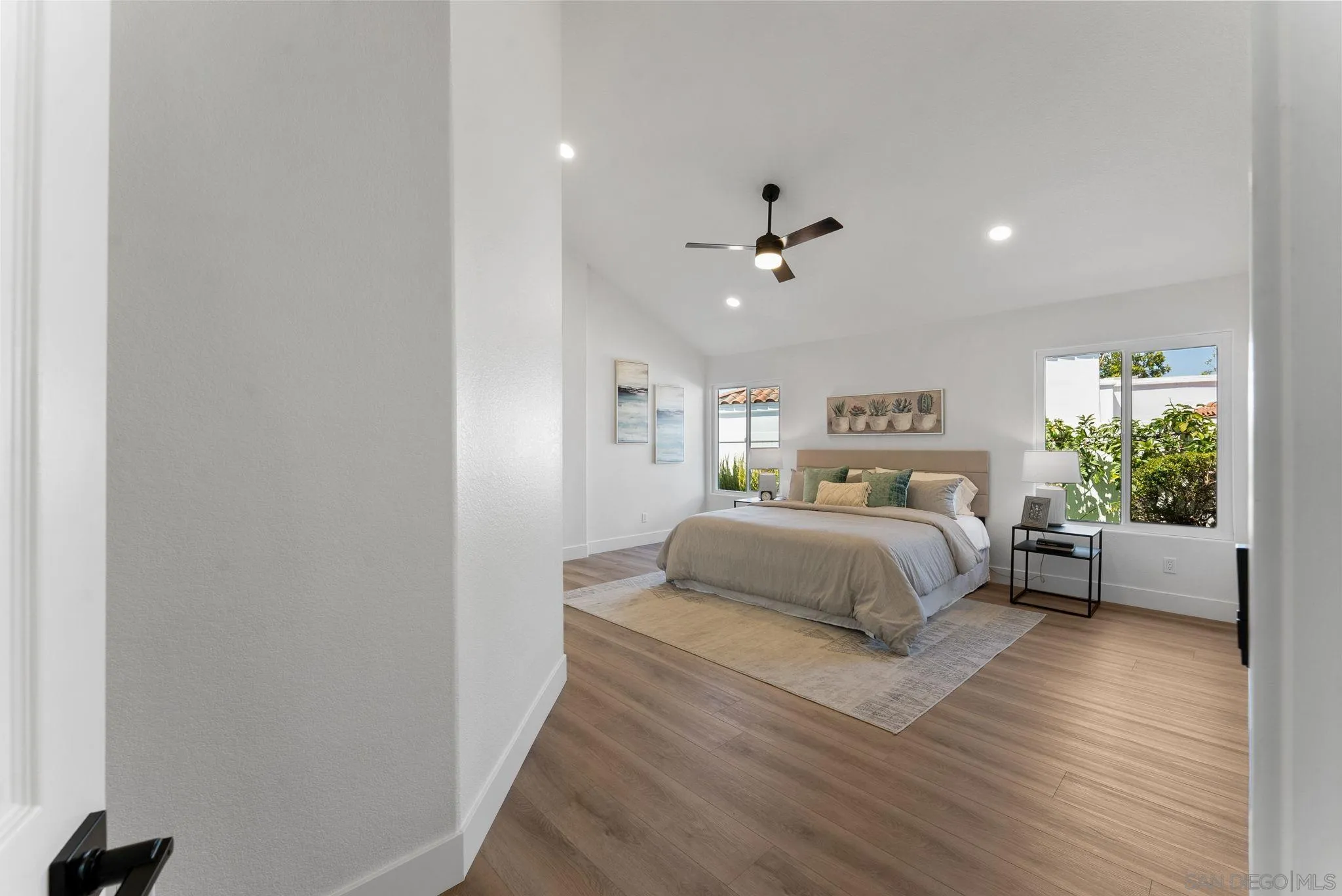 4714 Athos Way Oceanside, CA 92056 - Photo 22 of 34 a spacious bedroom with a bed and a couch