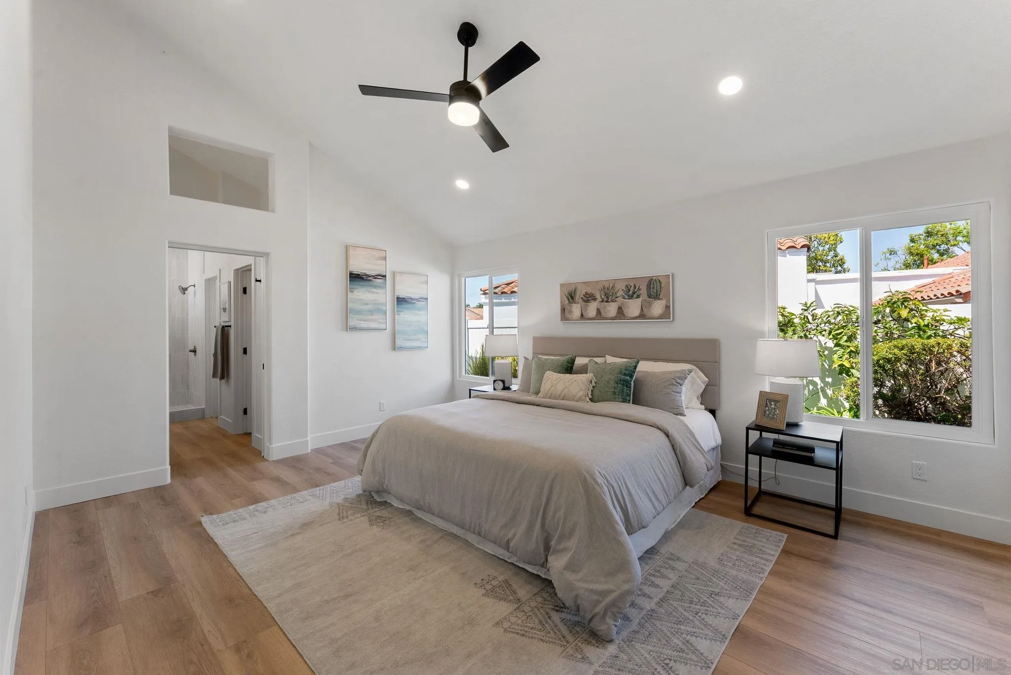 4714 Athos Way Oceanside, CA 92056 - Photo 23 of 34 a bedroom with a large bed and a chandelier