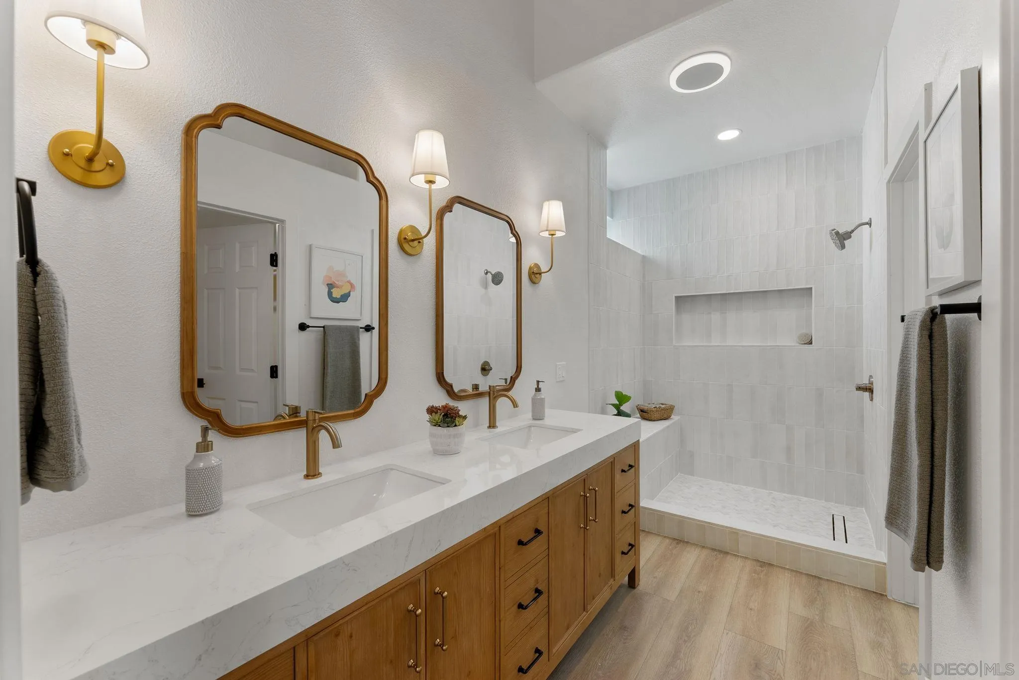 4714 Athos Way Oceanside, CA 92056 - Photo 24 of 34 a bathroom with double vanity sink and a mirror