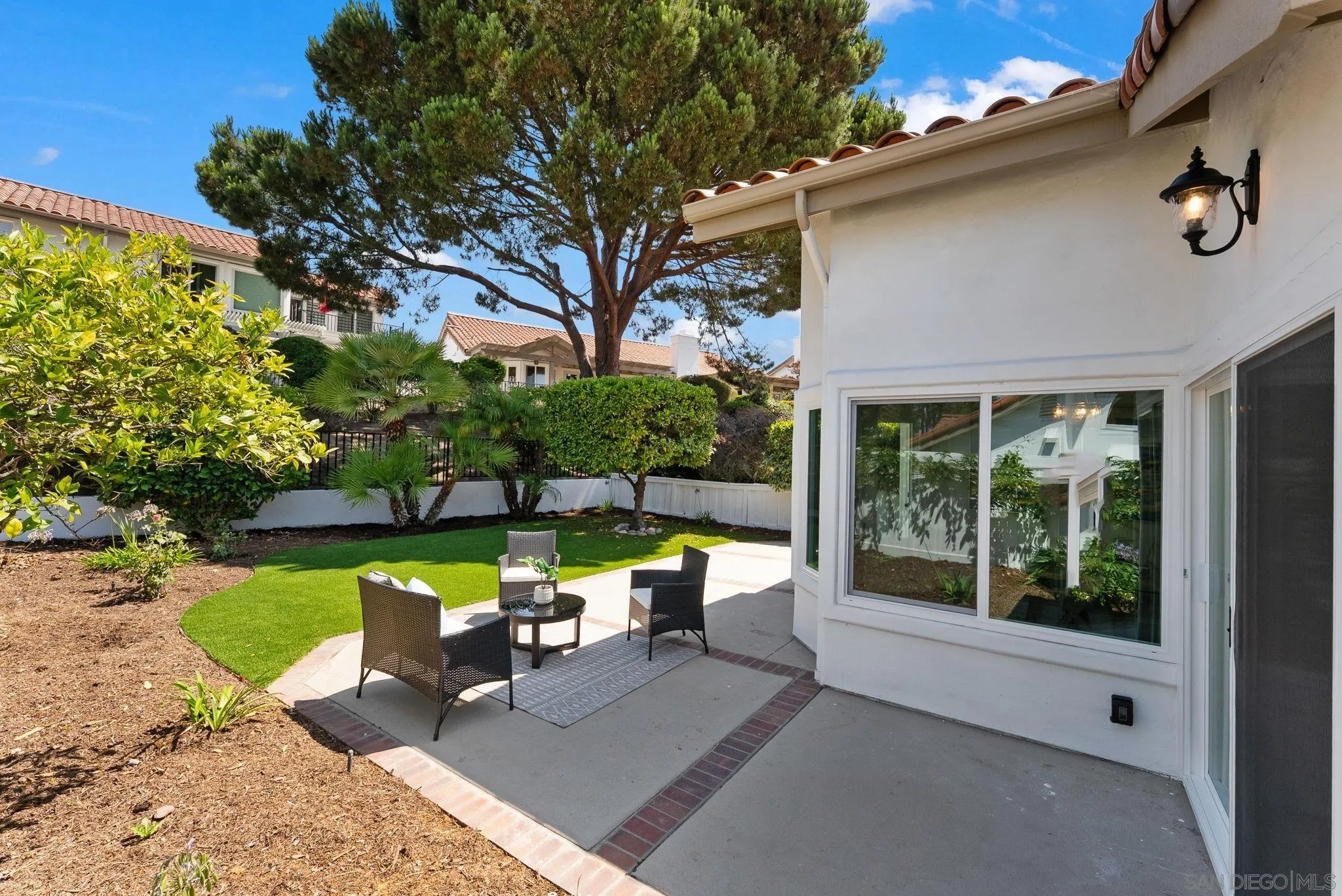 4714 Athos Way Oceanside, CA 92056 - Photo 28 of 34 a view of a patio with couches table and chairs and potted plants