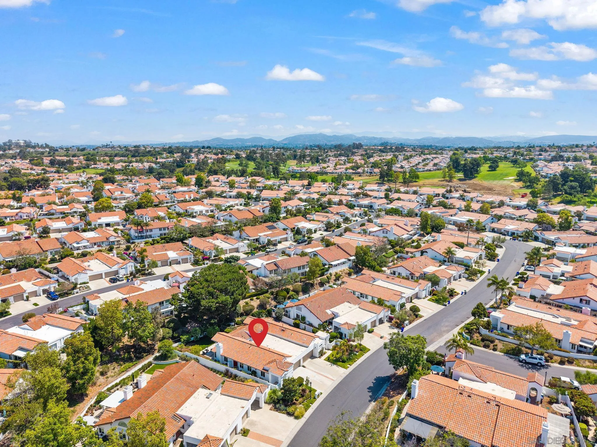 4714 Athos Way Oceanside, CA 92056 - Photo 33 of 34 an aerial view of a city with lots of residential buildings and mountain view in back