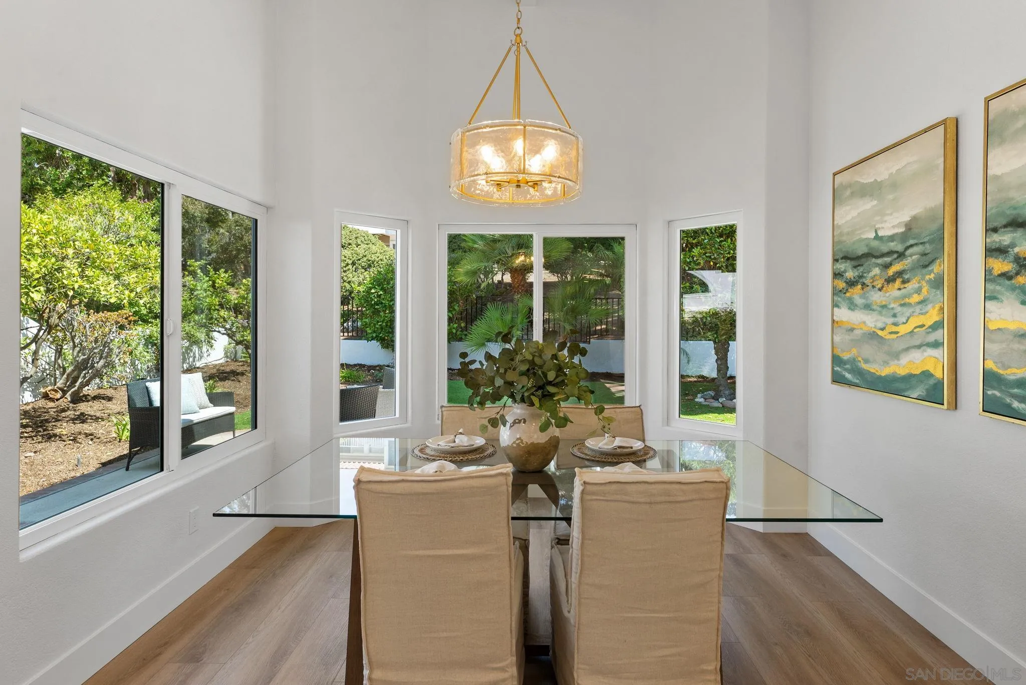 4714 Athos Way Oceanside, CA 92056 - Photo 6 of 34 a dining room with wooden floor and a floor to ceiling window