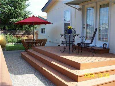 48 Yosemite Road, Unit 48 San Rafael, CA 94903 - Photo 7 of 8 a view of a patio with chairs and table under an umbrella with a fire pit