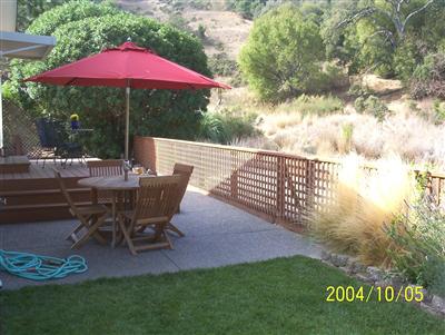 48 Yosemite Road, Unit 48 San Rafael, CA 94903 - Photo 8 of 8 a view of a patio with table and chairs under an umbrella