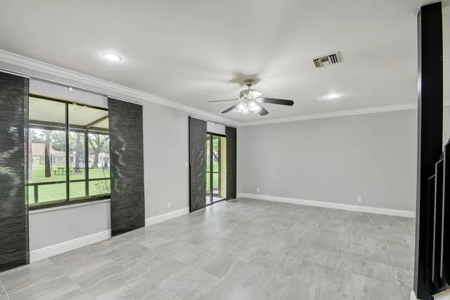 a view of an empty room with wooden floor