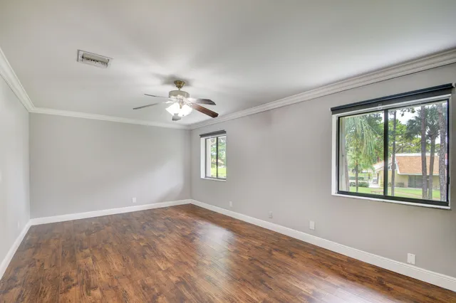 a white toilet sitting next to a white sink and vanity