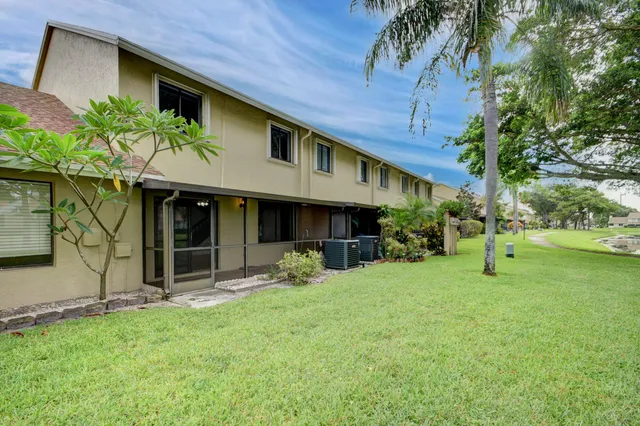 an aerial view of residential houses with outdoor space and river