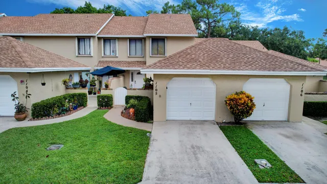 an aerial view of a house with garden space and street view