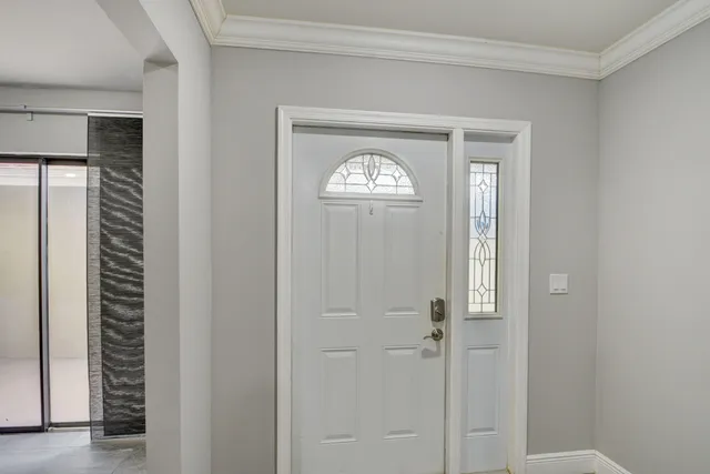 a large kitchen with cabinets and wooden floor