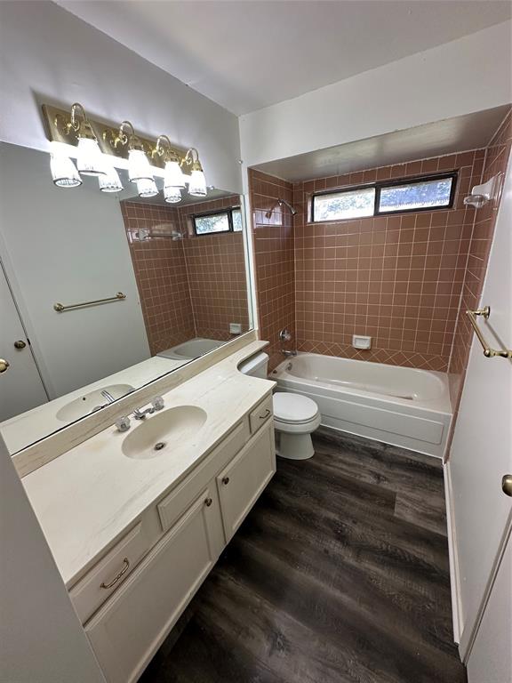 307 Harrington Lane Euless, TX 76039 - Photo 12 of 20 Full bath with tub / shower combination, vanity, and dark wood-style flooring