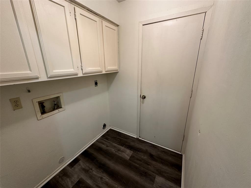 307 Harrington Lane Euless, TX 76039 - Photo 13 of 20 Washroom featuring washer hookup, dark wood finished floors, hookup for an electric dryer, and cabinet space