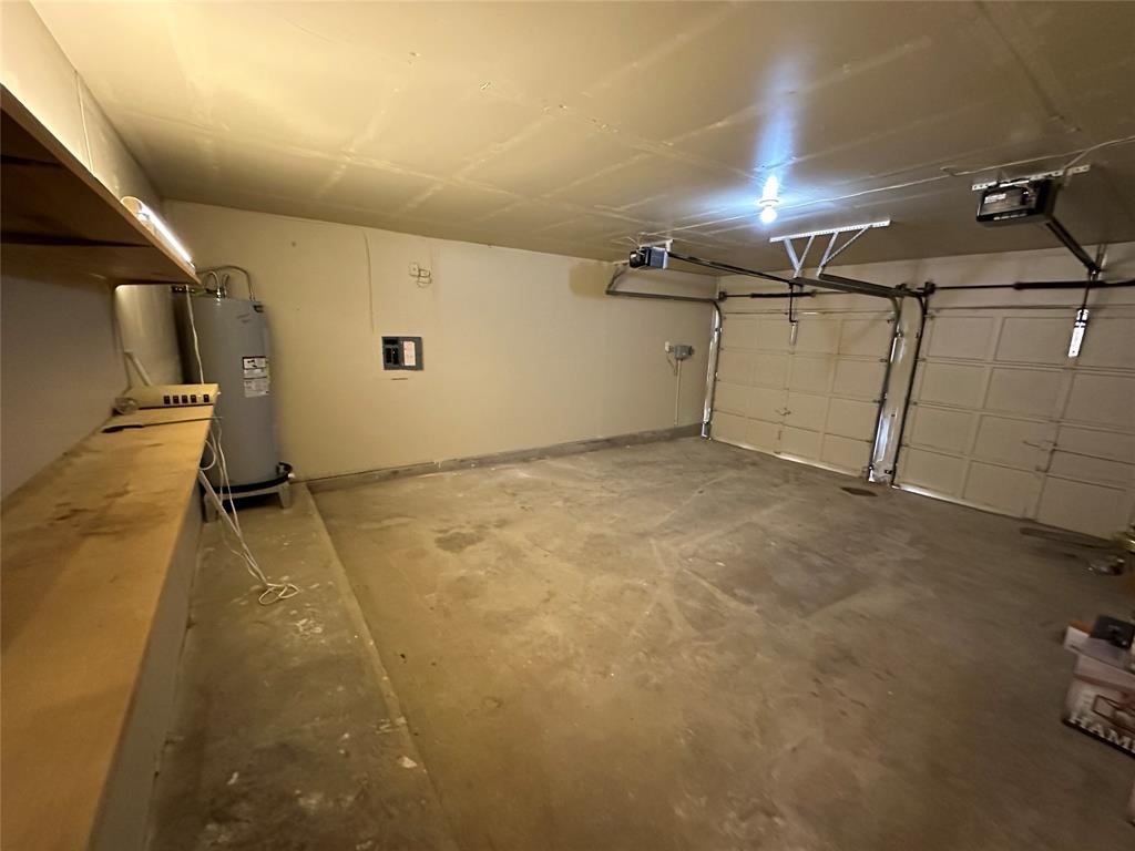 307 Harrington Lane Euless, TX 76039 - Photo 14 of 20 Garage featuring electric water heater and a garage door opener