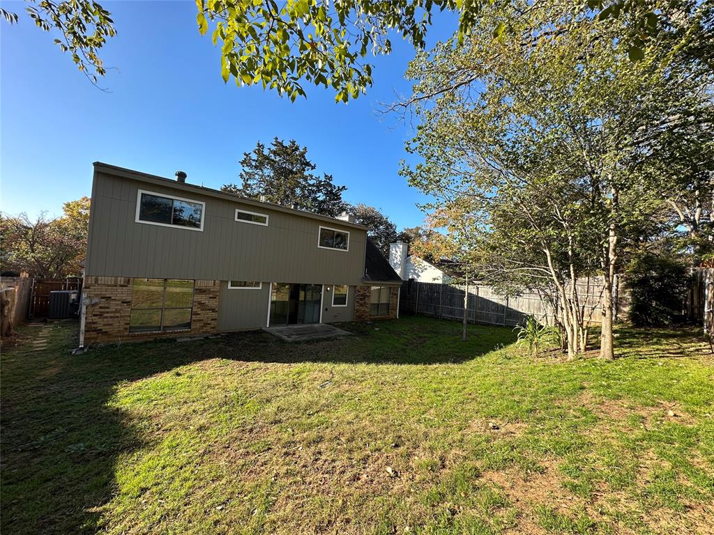 307 Harrington Lane Euless, TX 76039 - Photo 20 of 20 Rear view of house featuring brick siding, a fenced backyard, and a patio