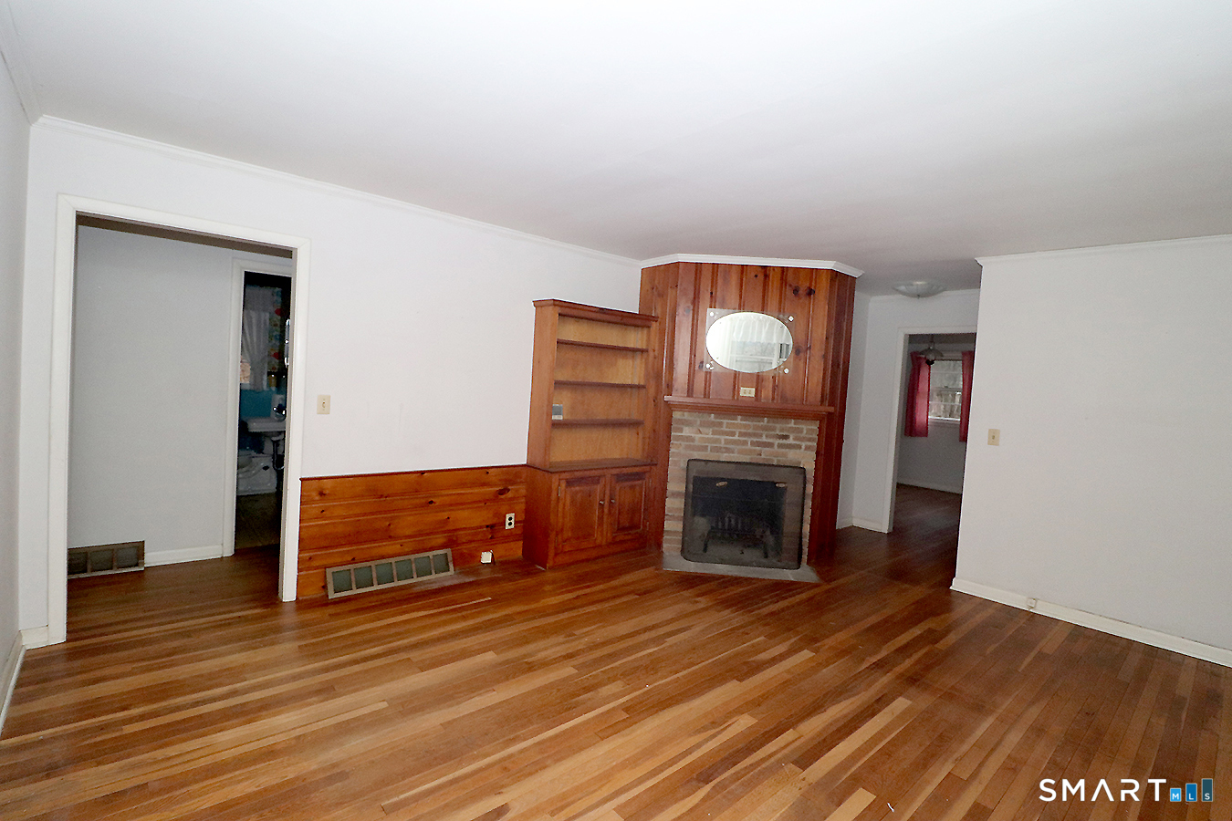 15 Connelly Road New Milford, CT 06776 - Photo 4 of 28 a view of a livingroom with wooden floor a fireplace and entryway