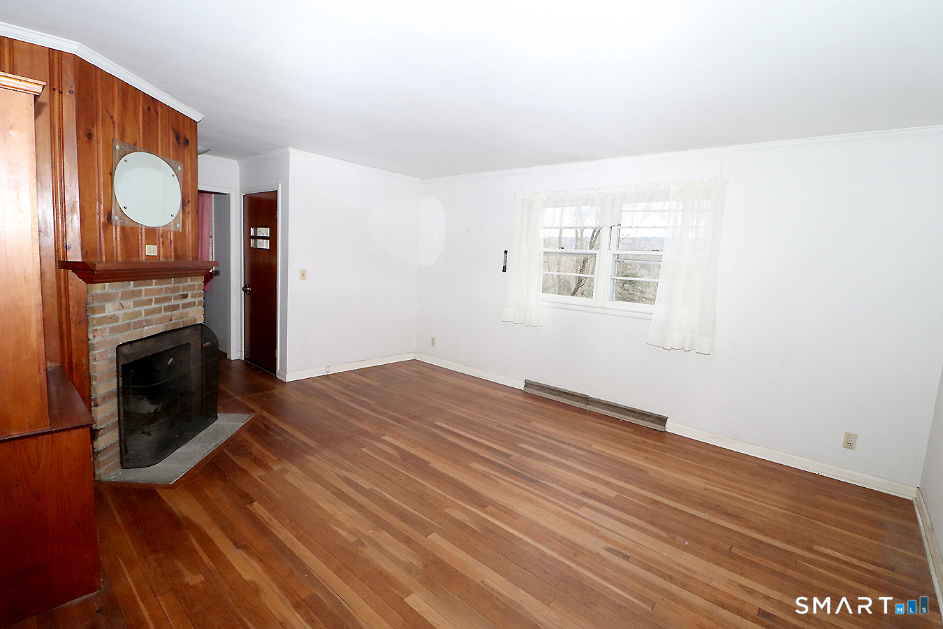 15 Connelly Road New Milford, CT 06776 - Photo 5 of 28 a view of an empty room with wooden floor and a window