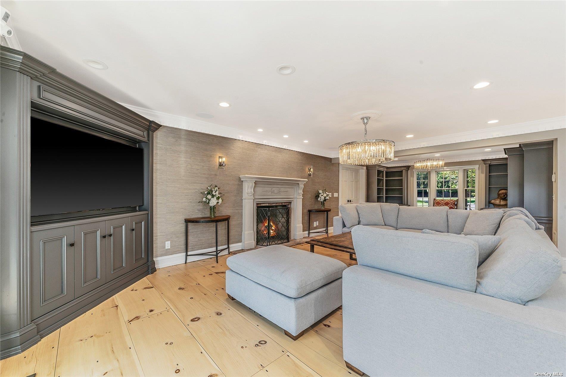 300 Maple Street Islip, NY 11751 - Photo 17 of 50 a living room with furniture a flat screen tv and a fireplace