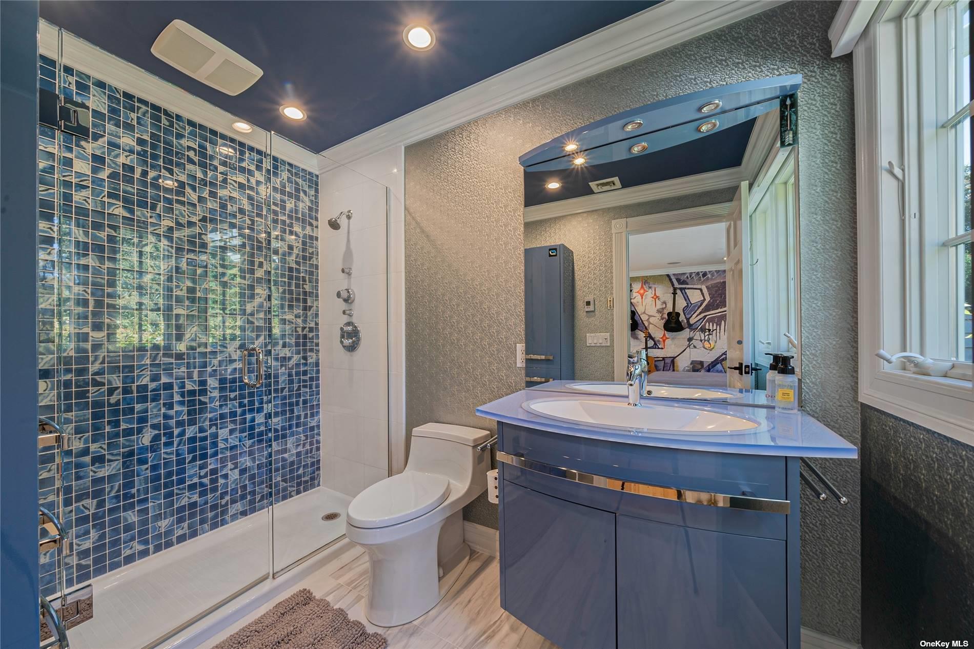 300 Maple Street Islip, NY 11751 - Photo 29 of 50 a bathroom with a sink a toilet a mirror and shower