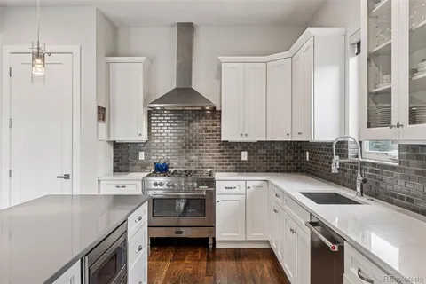 a kitchen with a sink stove and cabinets