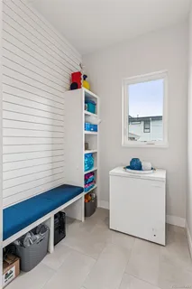 a room with furniture a window and wall paintings