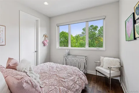 a bedroom with a bed and a chair