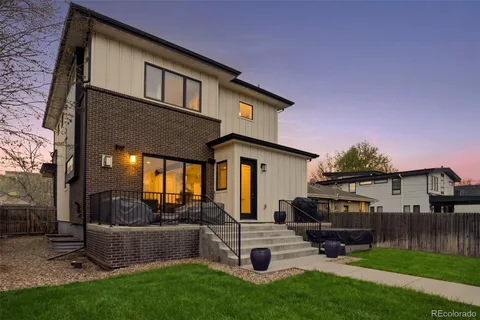 a front view of a house with a yard outdoor seating and slide