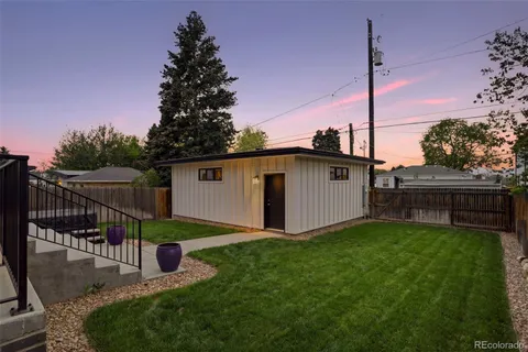 a view of a house with a yard and a fence