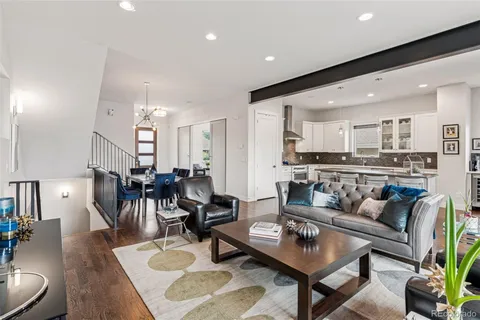 a living room with furniture and kitchen view