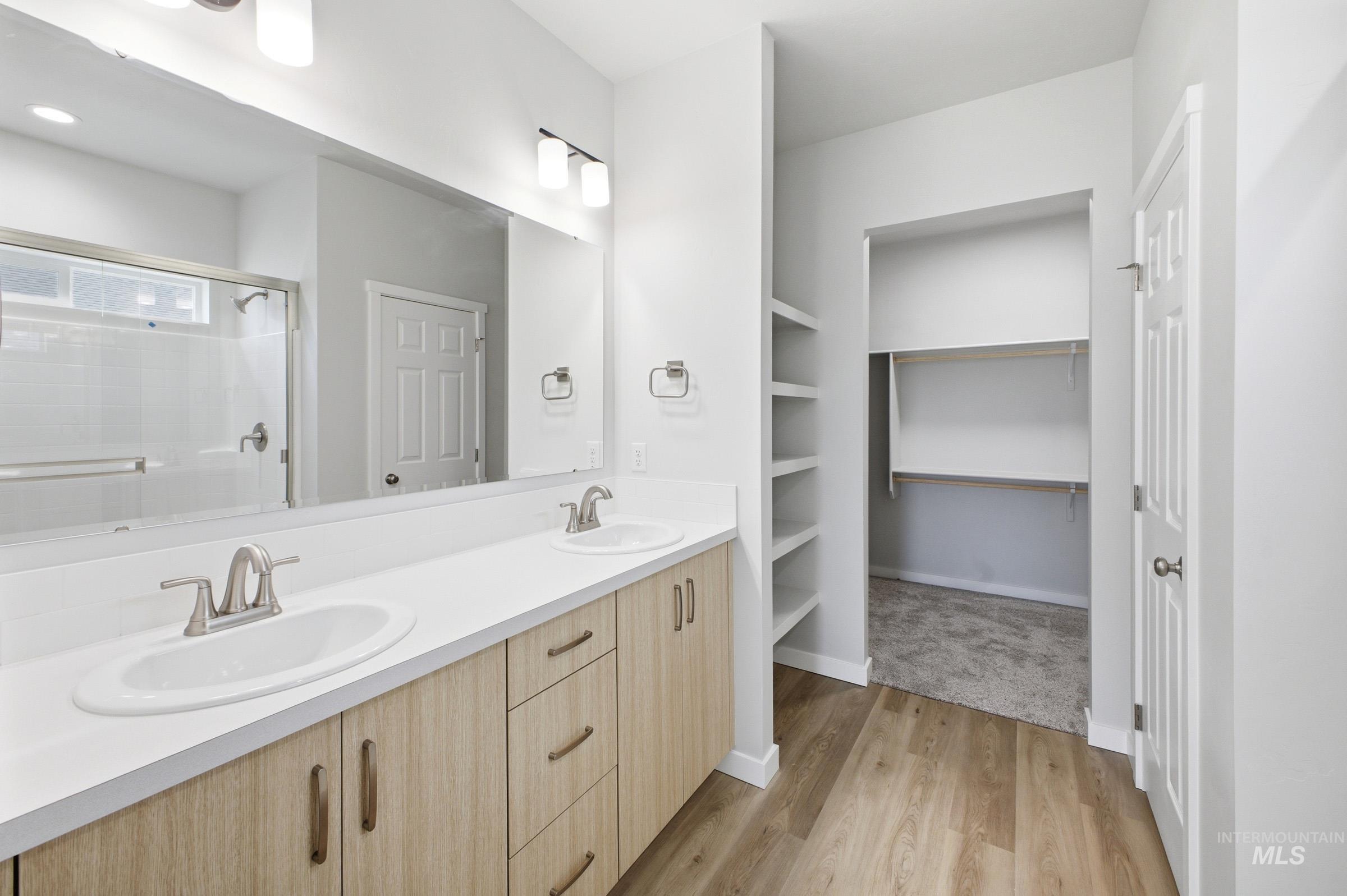 14104 Shiny Spruce Street Caldwell, ID 83607 - Photo 16 of 20 Bathroom featuring a dual vanity with light wood-finish cabinetry and white countertops