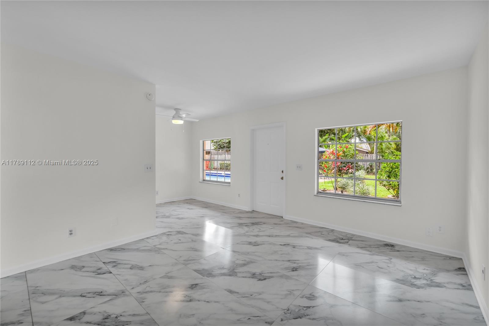 1405 Miami Road, Unit 5 Fort Lauderdale, FL 33316 - Photo 5 of 38 an empty room with windows