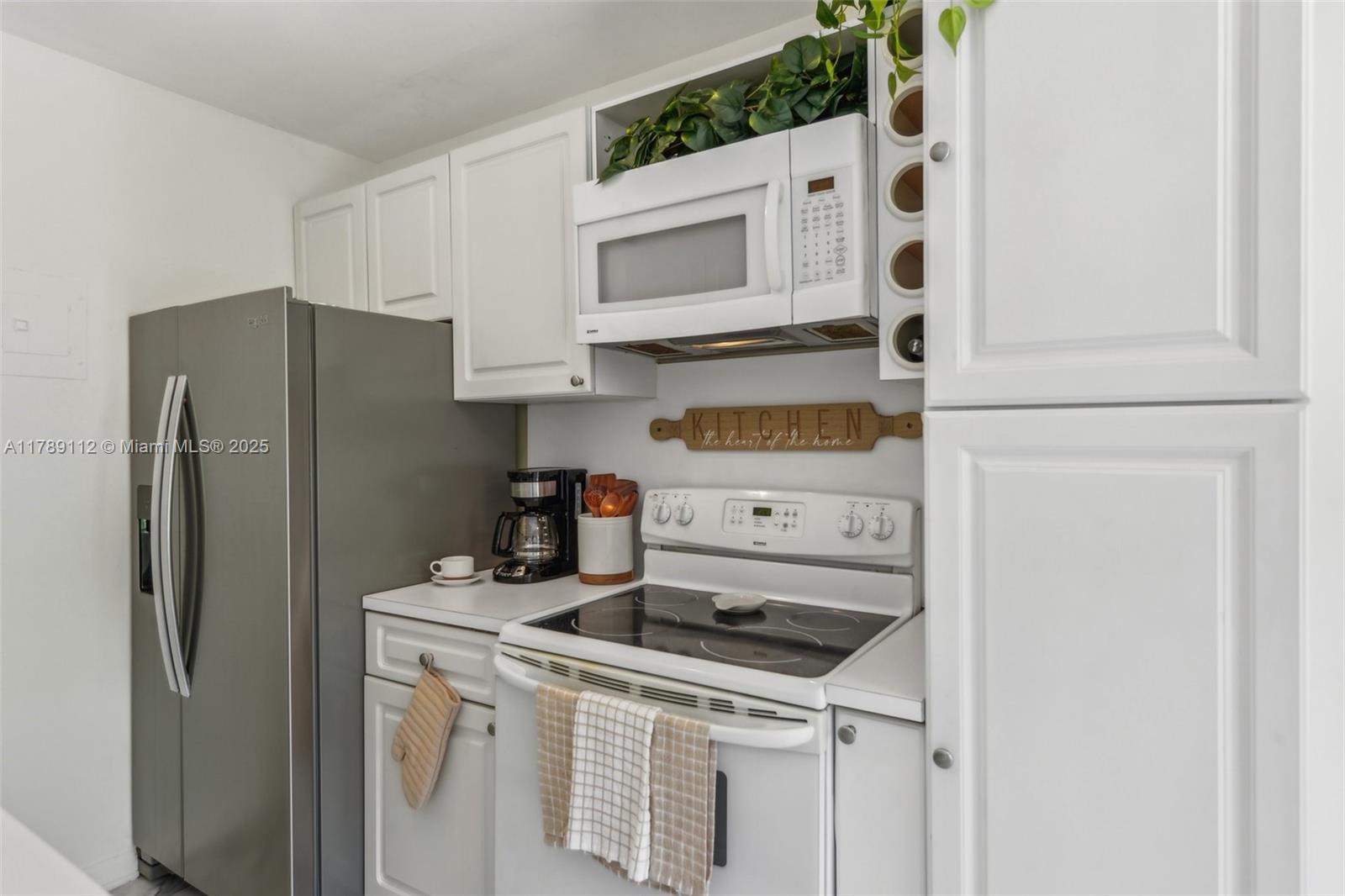 1405 Miami Road, Unit 5 Fort Lauderdale, FL 33316 - Photo 7 of 38 a kitchen with stainless steel appliances a refrigerator sink and cabinets