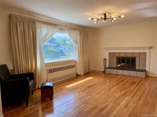 wooden floor fireplace and windows in an empty room
