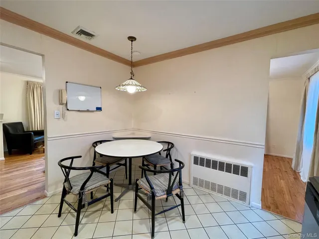 a view of a dining room with furniture and chandelier