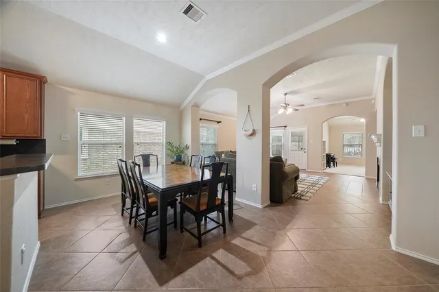 a view of a a dining room with furniture and window