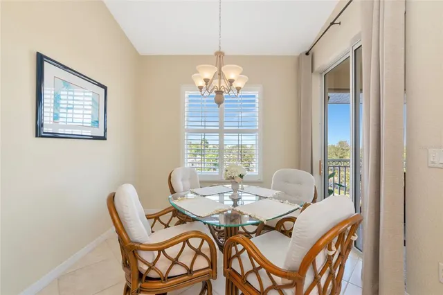 a dining room with furniture a chandelier and wooden floor