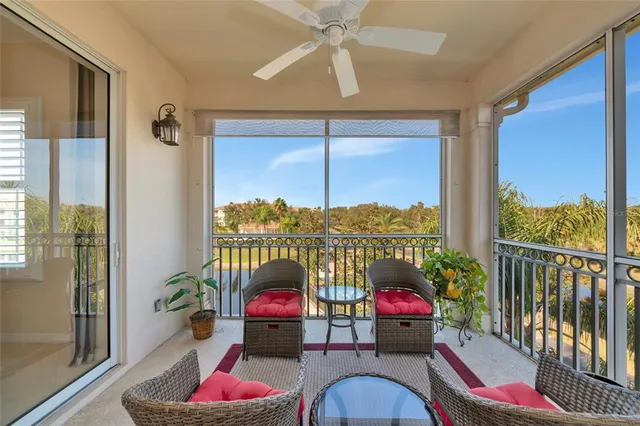 a living room with furniture and a floor to ceiling window