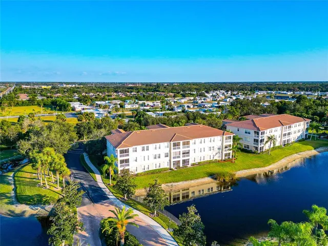 an aerial view of residential houses with outdoor space and swimming pool