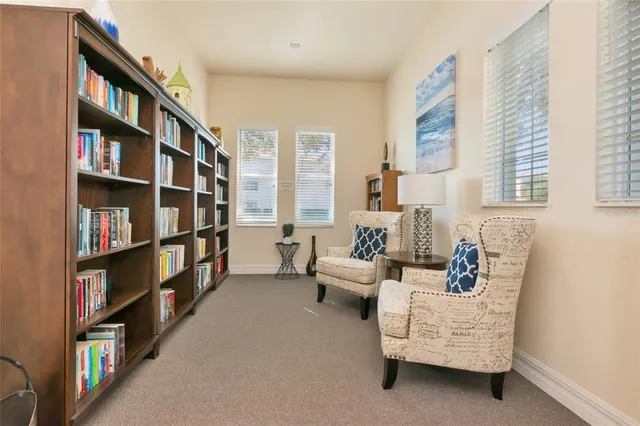 a living room with furniture and a book shelf