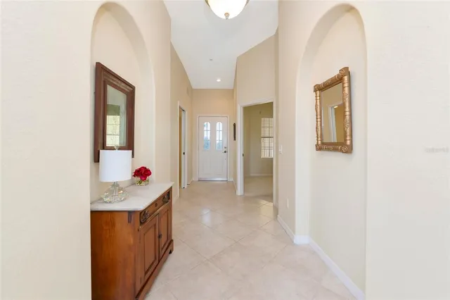 a view of a hallway to rooms and wooden floor