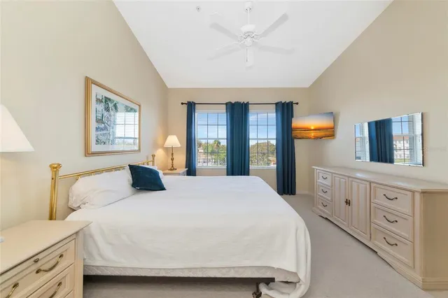 a bedroom with a large bed and a window