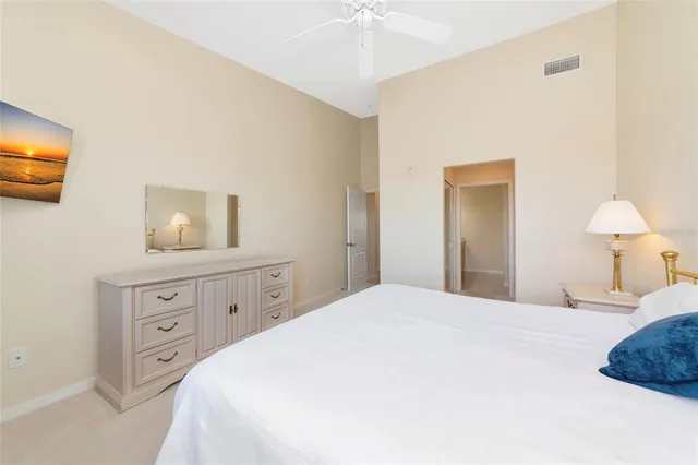 a bedroom with a bed and a lamp