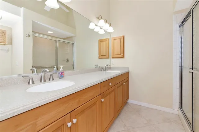 a bathroom with a double vanity sink and a mirror