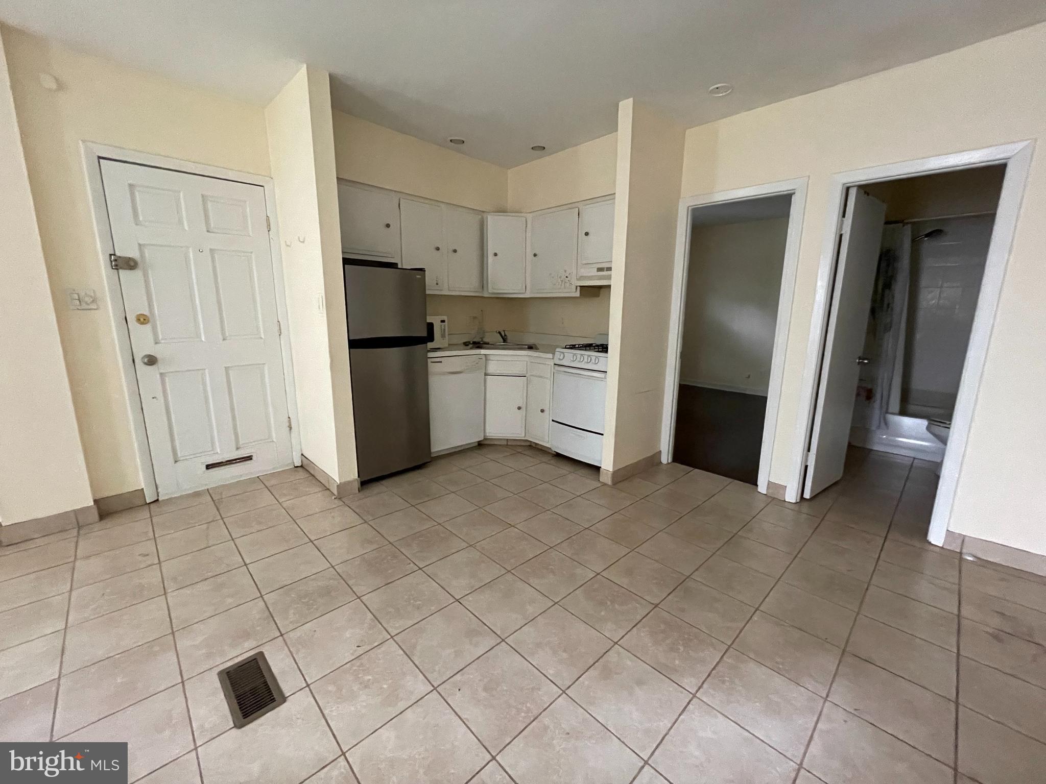 261 Queen Street, Unit 1 Philadelphia, PA 19147 - Photo 4 of 14 a kitchen with stainless steel appliances a refrigerator and a sink