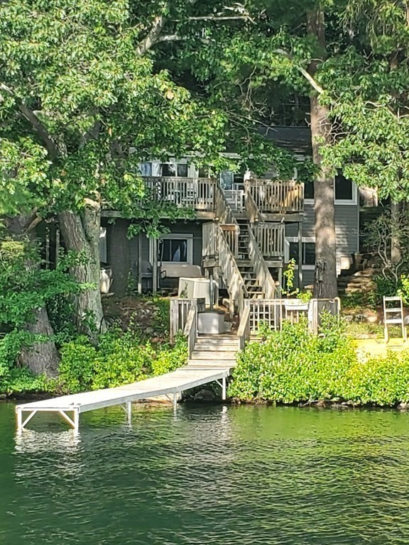 a view of a lake with a house swimming pool and outdoor space