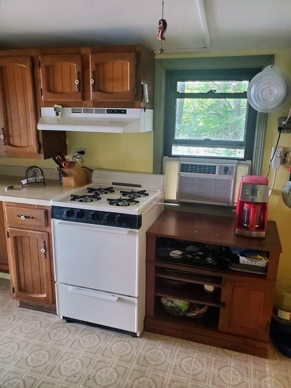 154 Lake Road Sturbridge, MA 01518 - Photo 4 of 39 a kitchen with stainless steel appliances granite countertop a stove and a microwave