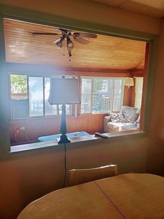 154 Lake Road Sturbridge, MA 01518 - Photo 7 of 39 a room with a chandelier fan and wooden floor