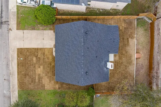 an aerial view of a house with a yard