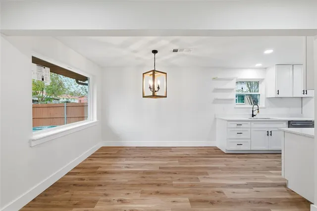 a room with a hardwood floor and window