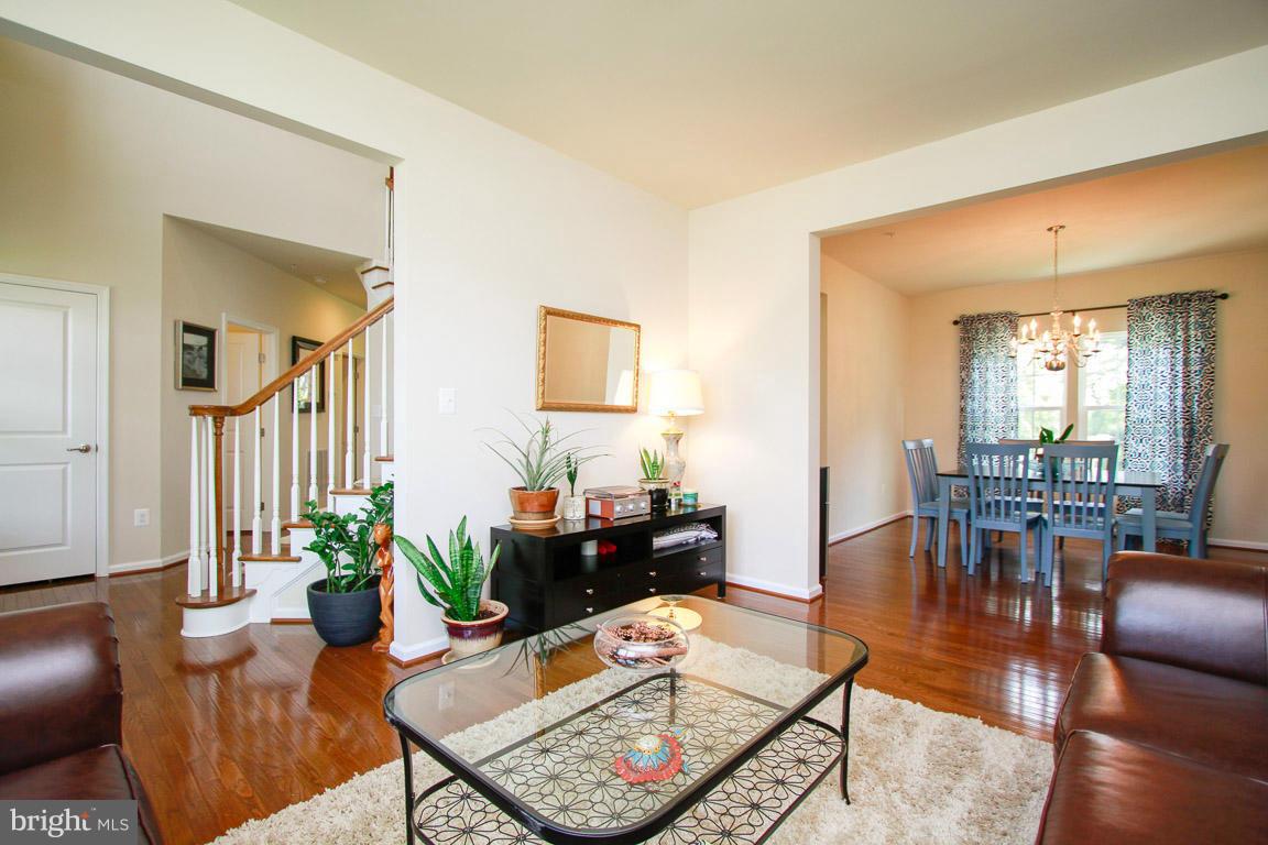 10502 Windlass Run Road Baltimore, MD 21220 - Photo 12 of 26 a living room with furniture a dining table and a potted plant