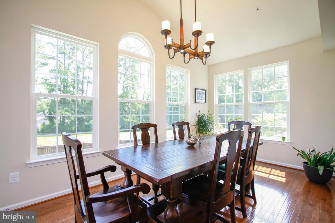 10502 Windlass Run Road Baltimore, MD 21220 - Photo 13 of 26 a view of a dining room with furniture window and wooden floor